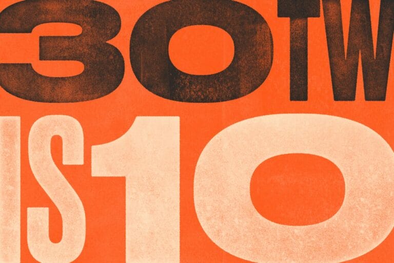 Bold, oversized numbers and letters in black and white are displayed on an orange background, with 30TW at the top—referencing 30 To Watch—and IS10 prominently featured below. The design has a vintage, textured appearance.