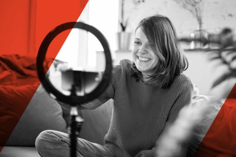 A woman sits on a couch, smiling at her smartphone while filming herself with a ring light—capturing the essence of a Campaign focused on Return on Influence. The image is mostly black and white with red diagonal stripes along the sides.