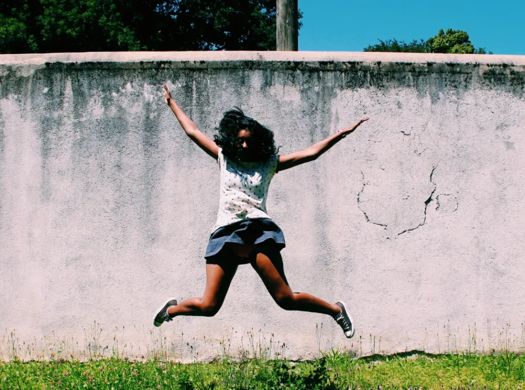 Girl doing a star jump