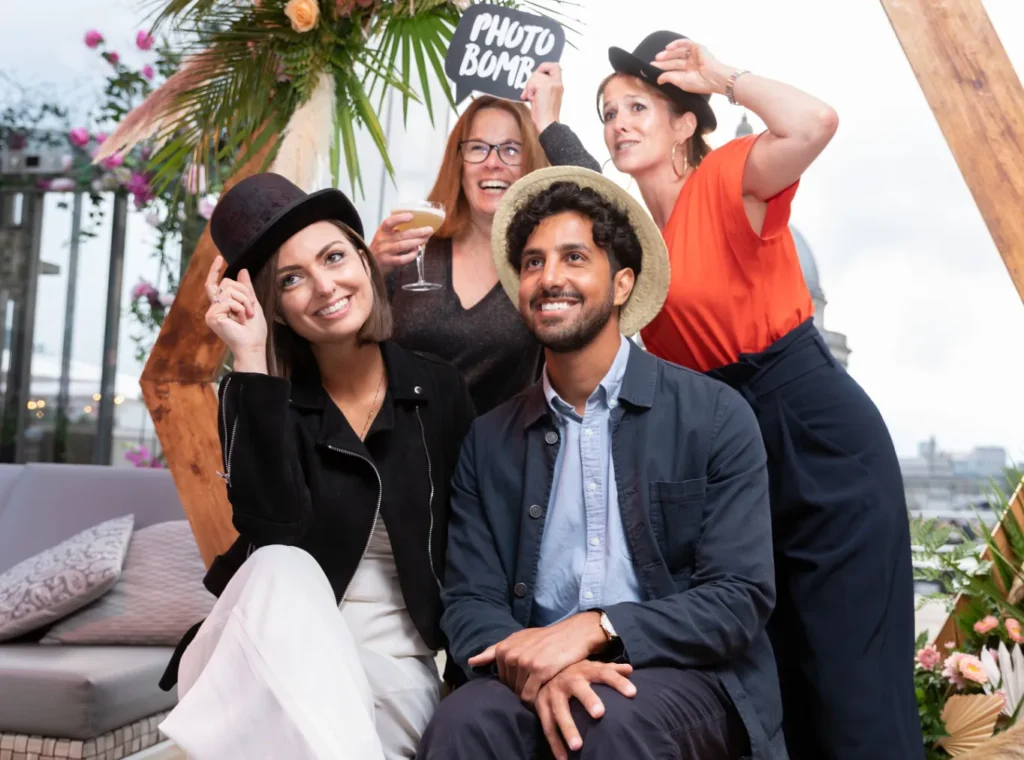 Four happy people in a photobooth