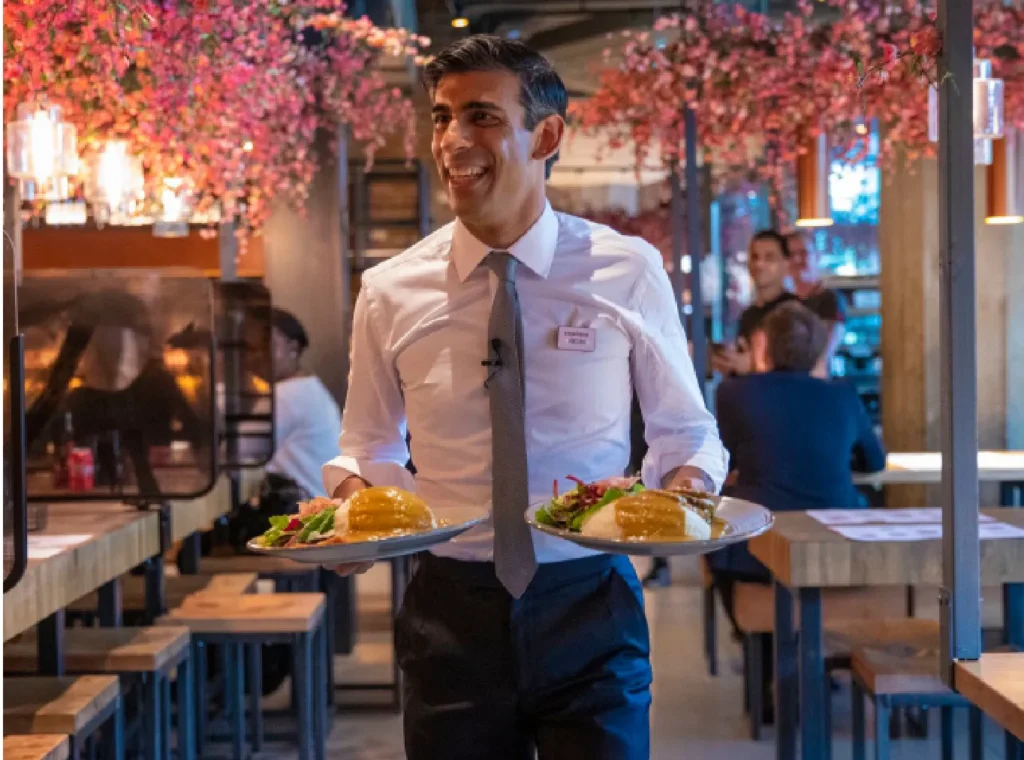 Rishi Sunak serving food